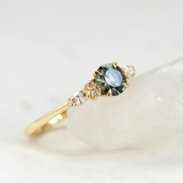 Close-up of the MAIDEN ring with natural green sapphire and diamond accents