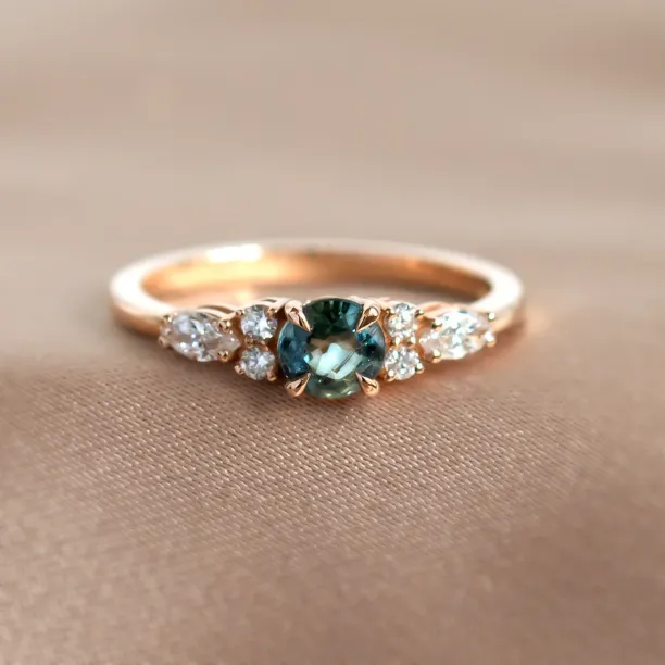 MAIDEN engagement ring with a natural green sapphire and side diamonds