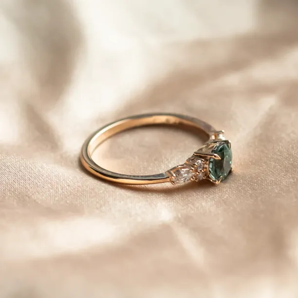 Angled view of the MAIDEN natural green sapphire and diamond engagement ring