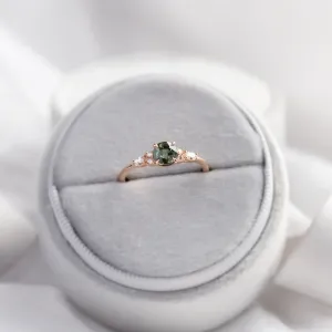 MAIDEN engagement ring with a natural green sapphire and diamonds on a ring cushion