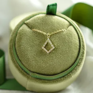 Gold necklace with lab-grown diamond kite pendant displayed on a cushion