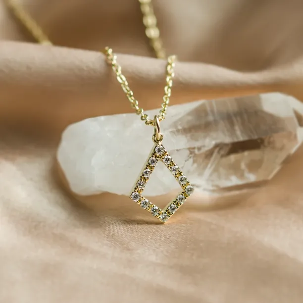 Angled close-up of the gold necklace with lab-grown diamond kite pendant