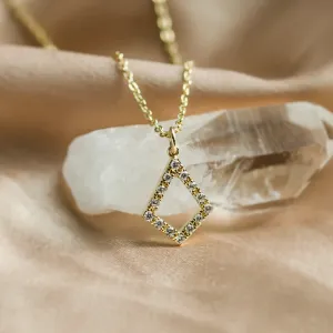 Angled close-up of the gold necklace with lab-grown diamond kite pendant