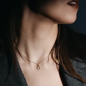 Gold HEATHER necklace with kite pendant worn around a woman’s neck