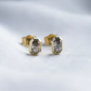 Close-up of NYLA gold stud earrings with salt and pepper diamonds
