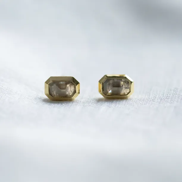 Horizontal view of NYLA gold stud earrings with salt and pepper diamonds