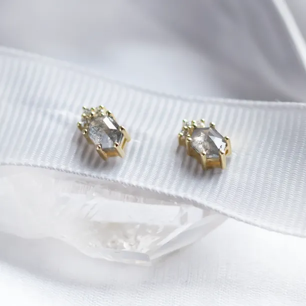 Angled view of TERRA stud earrings with salt and pepper diamonds