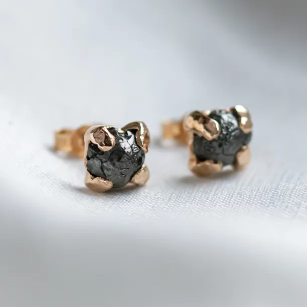 Angled close-up of CORDELIA earrings with rough grey diamonds