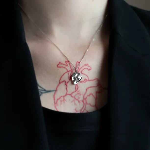 HEARTBEAT necklace with an organic pendant worn on the neck