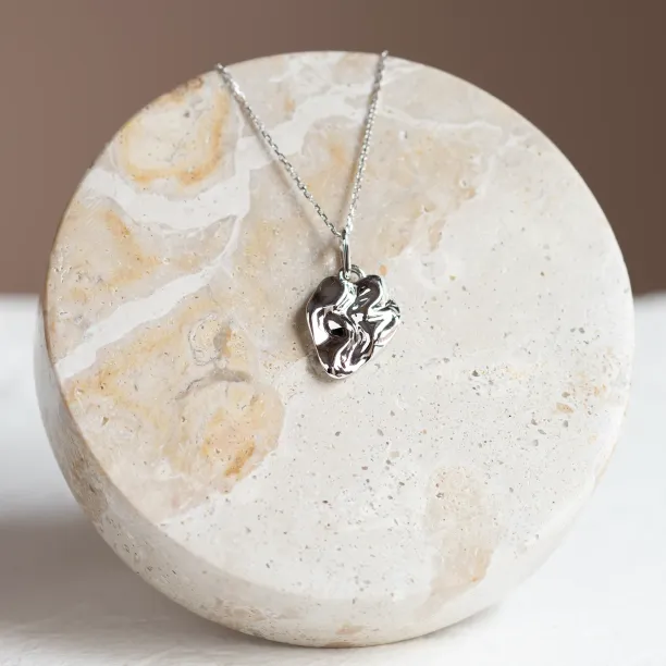 Close-up of the HEARTBEAT necklace and organic pendant