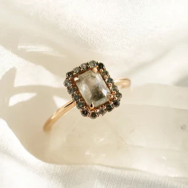 Angled close-up of the LUCIANA gold halo ring with salt and pepper diamonds