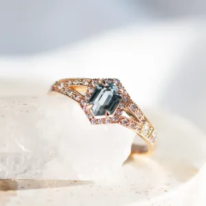 Angled close-up of the HARRIET ring with a hexagonal teal sapphire