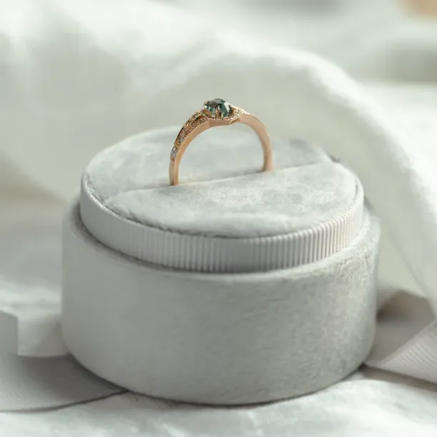 Profile view of the HARRIET engagement ring with raised teal sapphire