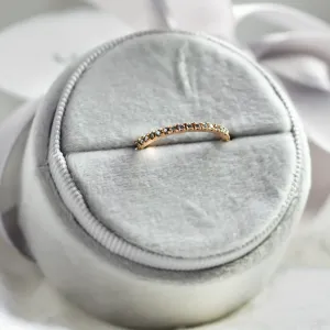 Close-up of DORA half eternity ring highlighting the salt and pepper diamonds