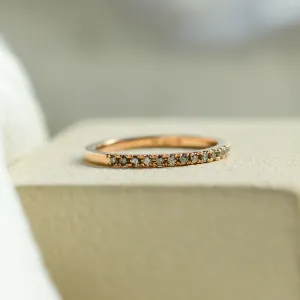Low angled view of DORA half eternity gold ring with salt and pepper diamonds