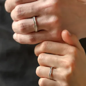SAVANNAH matching wedding rings worn on hands in close-up