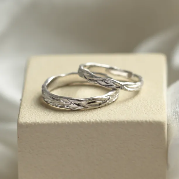 Angled view of KIRSTEN textured wedding rings