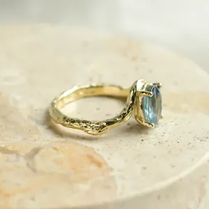 Side view of KIARA ring showing oval blue sapphire and irregular band