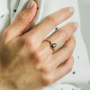 BLACKIE engagement ring with a black pear diamond worn on a finger
