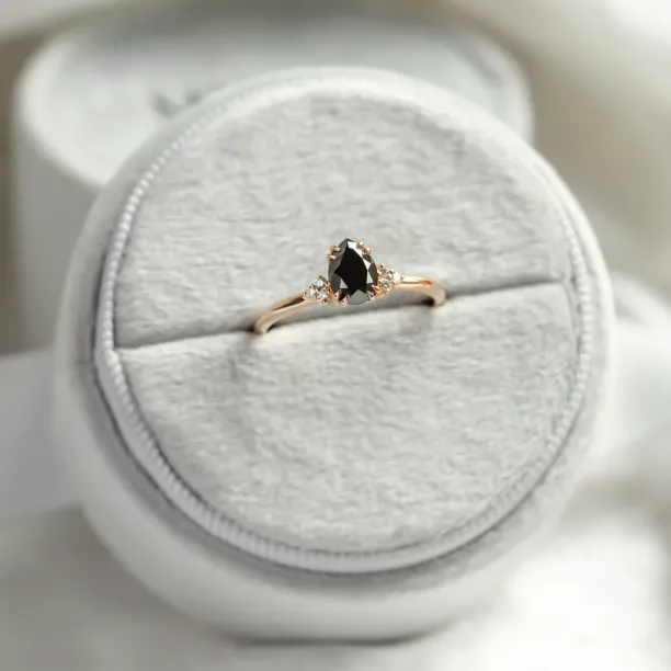 BLACKIE engagement ring displayed with a black pear diamond and side diamonds