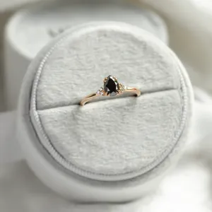BLACKIE engagement ring displayed with a black pear diamond and side diamonds