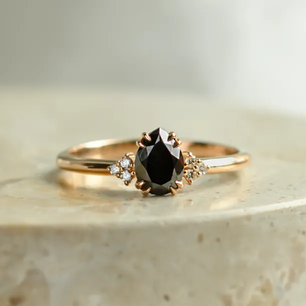 BLACKIE engagement ring with a black pear diamond and natural side diamonds