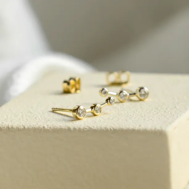 Angled view of MARIAN minimalist diamond earrings