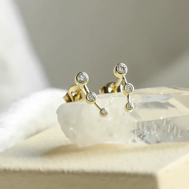 Angled close-up of MARIAN minimalist diamond earrings