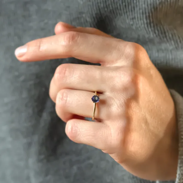 TANJA tanzanite engagement ring worn on a hand