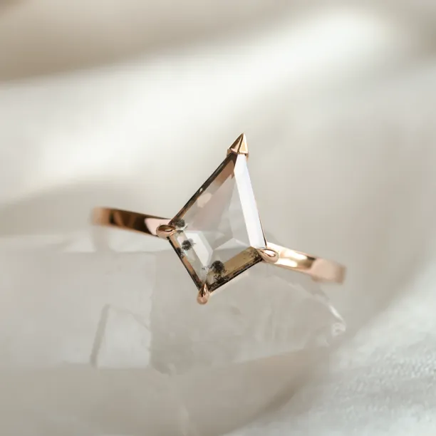Angled close-up of the CASEY gold ring and its kite-shaped diamond