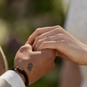 EDDY engagement ring with pink lab grown diamond worn between two hands