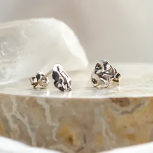 Angled close-up of CHÉRIE gold heart-shaped earrings and backs