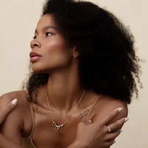 MIGNON gold wave earring worn on the ear in profile