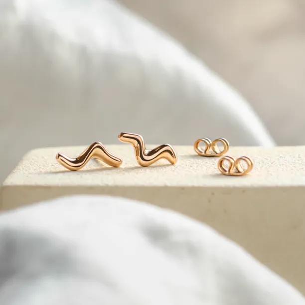 Rose gold MIGNON wave earrings shown as a pair