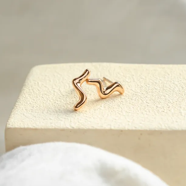 Angled view of the paired MIGNON wave earrings