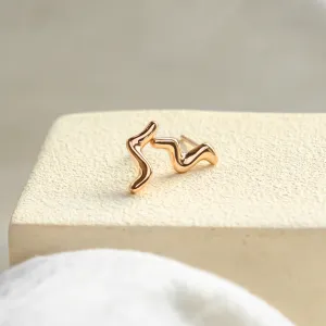 Angled view of the paired MIGNON wave earrings