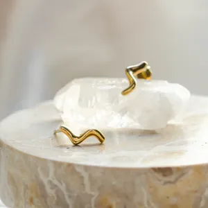 Gold MIGNON wave earrings shown together in a close-up