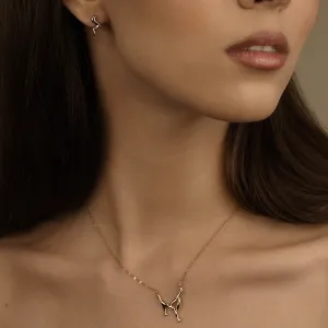 MIGNON wave earring worn on the ear in a close-up
