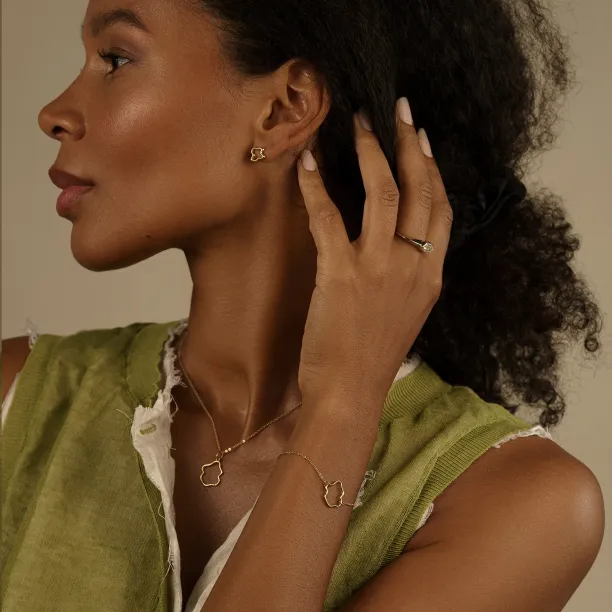 MICHELE gold bracelet worn on the wrist