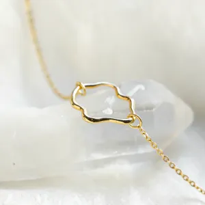 Angled close-up of the MICHELE gold bracelet centerpiece