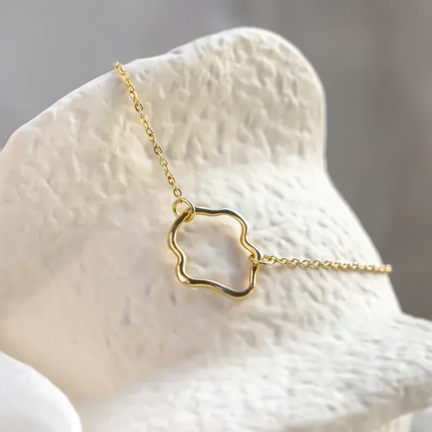 Close-up of the MICHELE gold bracelet with its open irregular centerpiece