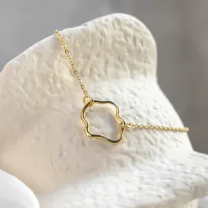 Close-up of the MICHELE gold bracelet with its open irregular centerpiece