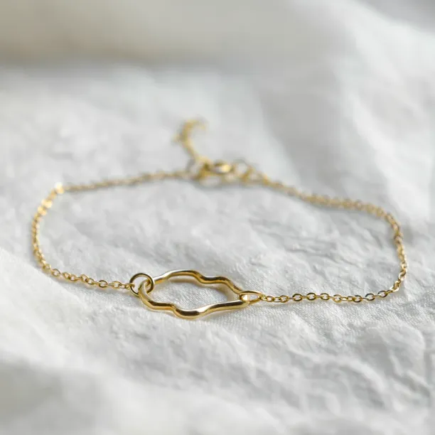 Full view of the MICHELE gold bracelet with an irregular centerpiece