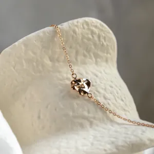 Angled close-up of the gold LAURENCE bracelet and irregular design element