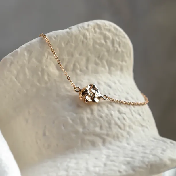 Angled close-up of the gold LAURENCE bracelet design element