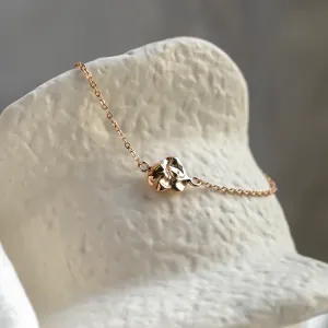 Angled close-up of the gold LAURENCE bracelet design element