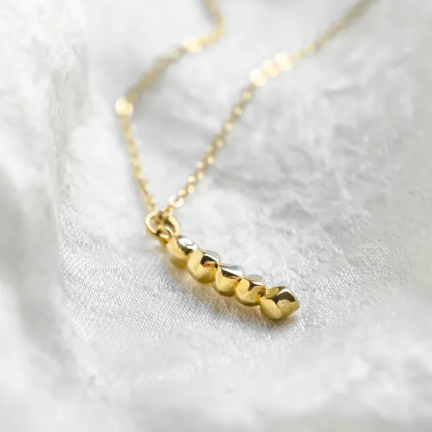 Close-up of the beaded CORINNE necklace pendant