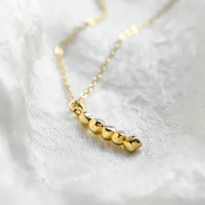 Close-up of the beaded CORINNE necklace pendant