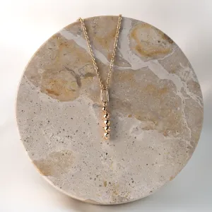 Full view of the gold CORINNE necklace with diamond pendant