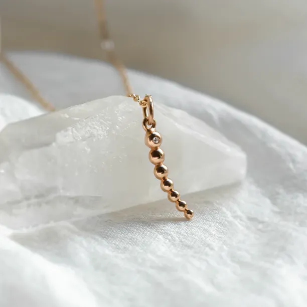 Close-up of the CLAUDE necklace pendant with a diamond